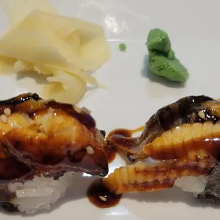 two pieces of sushi on a plate