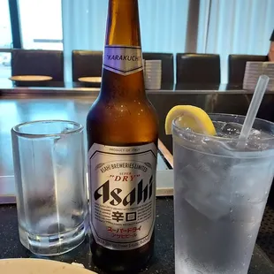 a glass of water and a bottle of beer