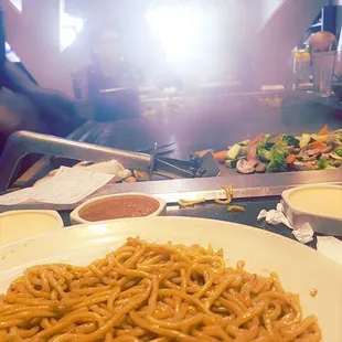 Noodles, and the chef is cooking the vegetables.