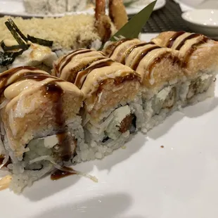 Oyster Roll: Crispy Fried Oyster with Cream Cheese, and Cucumber on the inside. Topped with Lobster on the outside.