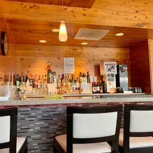 a bar with a lot of liquor bottles