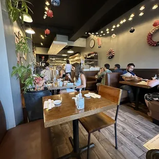 people sitting at tables in a restaurant