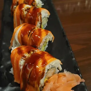 a sushi roll on a black plate