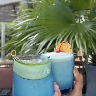 two people toasting with drinks