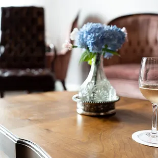 a glass of white wine on a table