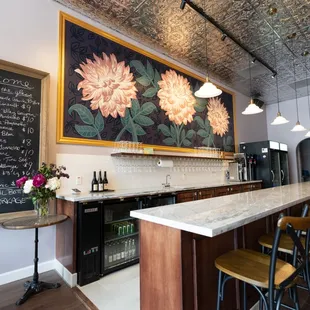 a bar with chairs and a chalkboard
