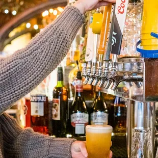 a woman pouring a beer