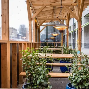 a patio with benches and potted plants