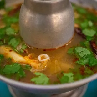 a bowl of soup on a blue plate