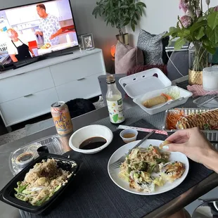 a woman sitting at a table with plates of food