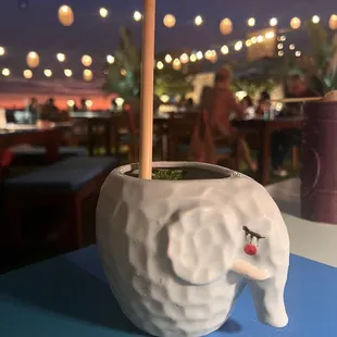 an elephant cup with a straw in it