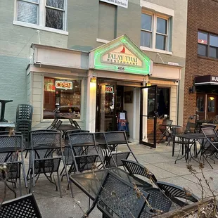 outside of restaurant with tables and chairs