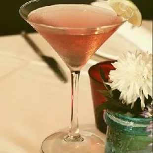 a pink cocktail in a coupe glass