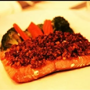 a piece of salmon and broccoli on a plate