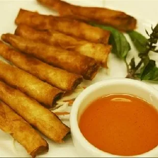 a plate of food with dipping sauce