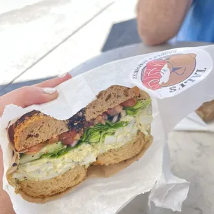 The Bubbe (lemon dill egg salad) with veggies on an everything bagel