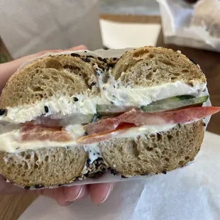 Inside my sesame seed lemon dill schmear with tomato, cucumber and red onions.