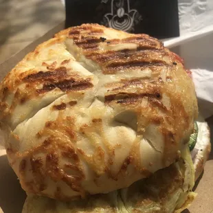 a close up of a sandwich on a paper plate