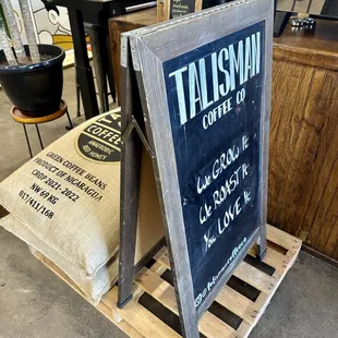 a chalkboard sign for a coffee shop