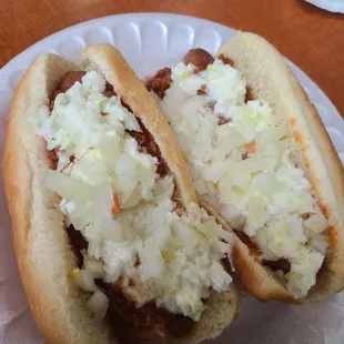 two chili dogs on a paper plate