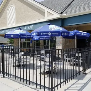 a restaurant with tables and umbrellas