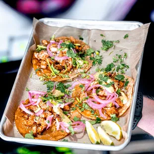  person holding a tray of food