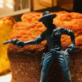a blue cowboy figurine on top of a cake