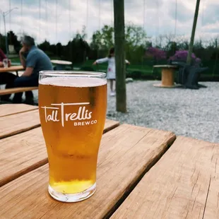 a pint of beer on a wooden table