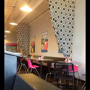 a dining area with tables and chairs