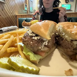 Black and blue burger with fries.