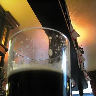 a glass of dark beer