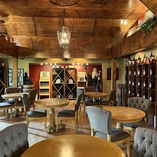 a wine tasting room with tables and chairs