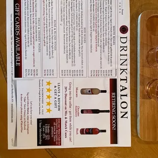 a menu and wine glasses on a table