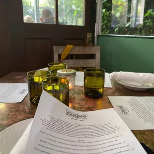 a table with glasses and a menu