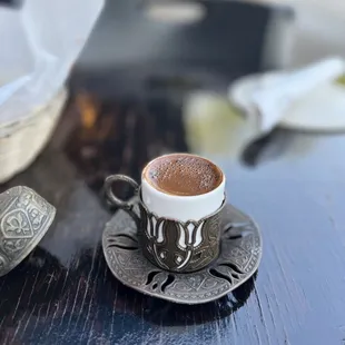 a cup of coffee on a saucer