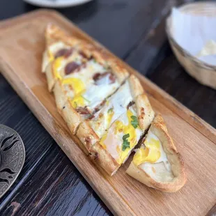 a wooden cutting board with a pizza on it