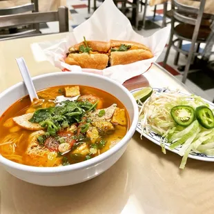 a bowl of soup and a plate of hot dogs