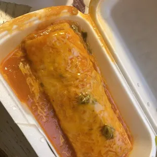 an enchilada in a styrofoam container
