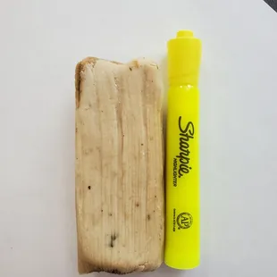 a piece of bread and a yellow marker