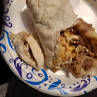 a burrito on a paper plate