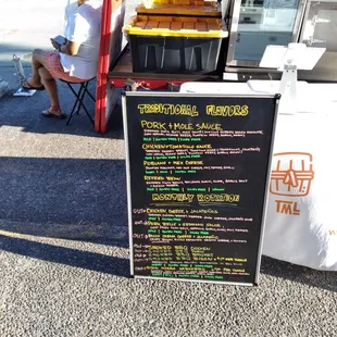 a woman sitting at a table with a menu