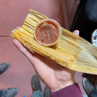 a person holding a tamalena