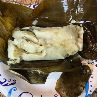 Pork tamale in banana leaf.