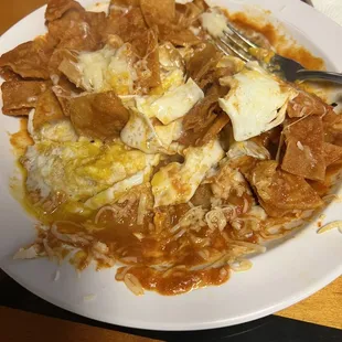 Chiliquilas mixed with 2 over easy eggs