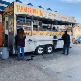 people ordering food from a food truck