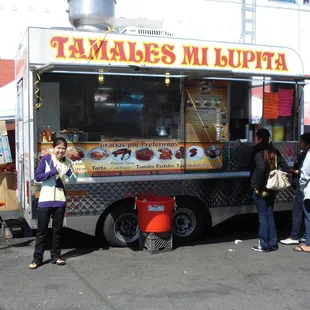 people standing in front of a food truck