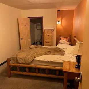 "Chalet" #10, unlocked with dirty bedding and towels on the floor.