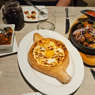 cheesy egg bread, vegetable medley, chicken and potato clay pot, natural Georgian soda