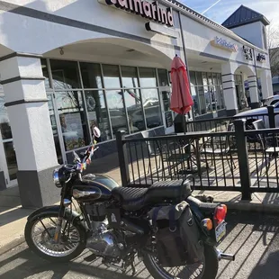 a motorcycle parked in front of a restaurant