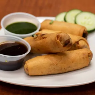 a plate of food with dipping sauce